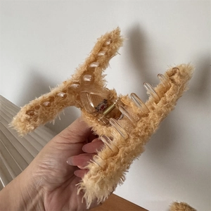 Detailed view of the soft plush bear hair claw clip showing fluffy texture and secure grip
