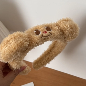 Detail view of the plush brown bear headband showing soft faux fur texture and embroidery