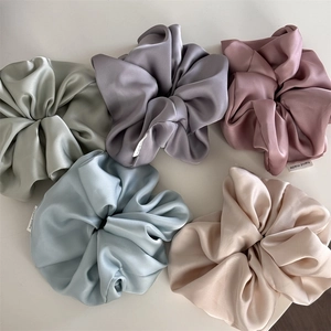 Five oversized satin scrunchies in Morandi colors with handmade woven labels