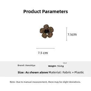 Detail showing leopard print fabric flower hair clip with a central pearl decoration
