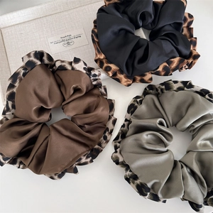 Three-piece leopard print trim scrunchies set in brown, black, and green satin fabric