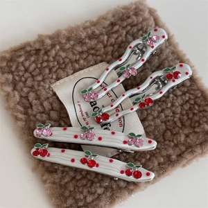 Four-piece set of white polka dot hair clips with red cherry rhinestones and wavy patterns