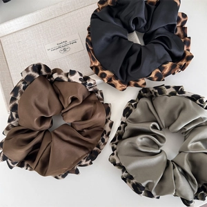 Three elegant leopard print satin scrunchies in black, coffee, and grey green colors