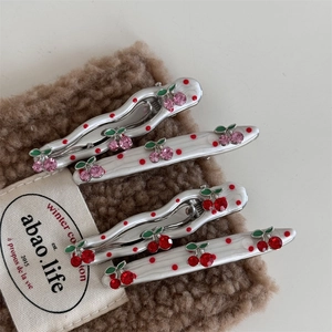 Cute cherry hair clips with red rhinestones and polka dots on silver duckbill clips