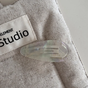 Detail of laser finish drop-shaped acetate hair clip with France Handmade lettering