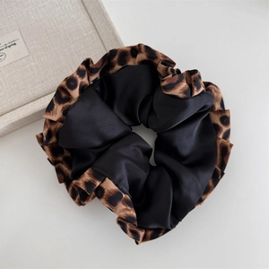 Detailed view of leopard print and black satin dual-design large hair scrunchie accessory