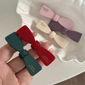 Barrettes à cheveux nœud en acétate de diverses couleurs avec inscription dorée élégante