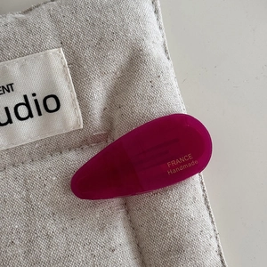 Detail view of purple acetate water-drop hair clip with France Handmade gold lettering