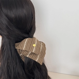 Vintage brown striped hair scrunchie with golden heart accent on long black hair