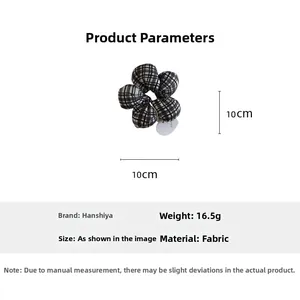 Detail view of a black and white checkered fabric flower scrunchie with 10x10cm dimensions