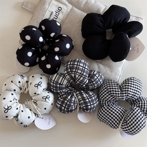 Detail of five-piece set black and white floral scrunchies with polka dots and plaid patterns