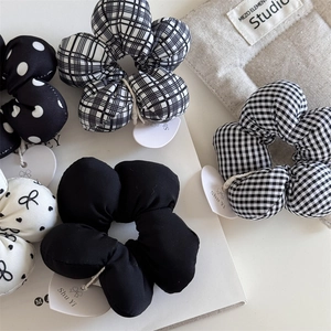 Detail view of cotton flower scrunchies set featuring polka dots and plaid patterns