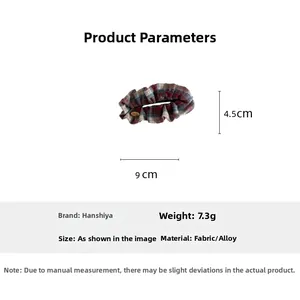 Detailed view of red and blue plaid hair scrunchie with love charm and dimensions