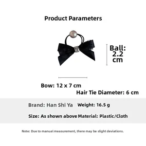 Detail of black lace bow hair tie with a 2.2cm pearl ornament and elastic band