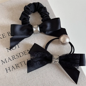Elegant black bow hair scrunchies with crystal and pearl accents for stylish ponytails