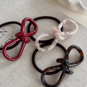 Three-piece acetate knot hair tie set in red, marble, and tortoise shell patterns