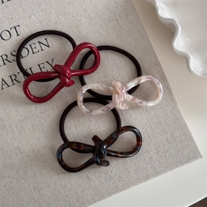 Detailed view of high-elasticity hair ties with resin knots in marble and wine red