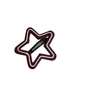 Deep red polka dot star-shaped leather hair clip with white stitching and metal base