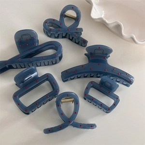 6-piece set of matte blue hair claws with red polka dots in various chic geometric shapes