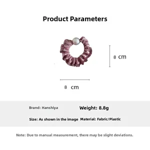 Detail view of pink velvet hair scrunchie with large pearl and size specifications