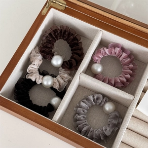 Five-piece velvet scrunchie set with large pearls in brown, beige, pink, and grey