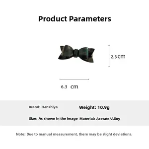 Detail view of acetic acid bow hair clip showing dimensions 6.3cm x 2.5cm and 10.9g weight