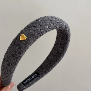 Detail of grey tweed wide headband featuring a gold heart buckle and handmade label