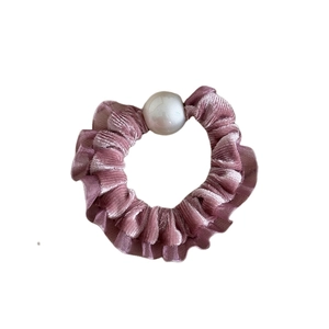 Pink velvet hair scrunchie with large white pearl detail for ponytails and buns
