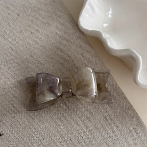 Detail of a handmade double-layered acetate hair clip with vintage marble texture