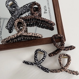 Three leopard print fabric hair claws in brown and black vintage aesthetic style