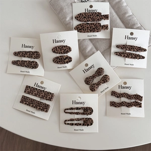 Close-up of vintage leopard print hair clip set in various geometric shapes on cards