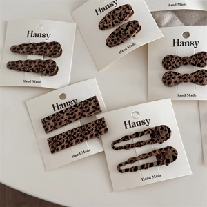 Pair of vintage leopard print acetate duckbill hair clips for women in multiple shapes