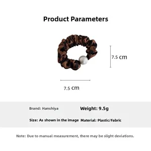 Detail showing leopard print hair scrunchie with large white pearl and 7.5cm diameter measurement