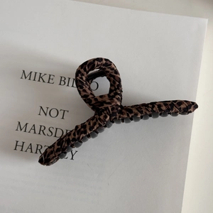 Close-up of leopard print fabric texture on a large stylish hair claw clip
