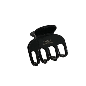 Elegant black acetate hair claw clip with golden France Handmade lettering in 45-degree view
