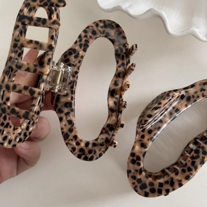 Close-up of leopard print acetate hair claw clips with strong metal spring for thick hair