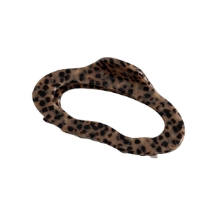 Thick acetate hair claw clip with brown leopard pattern and wavy design on white background