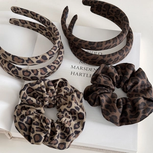 Detailed set of leopard print fabric headbands and matching hair scrunchies for women