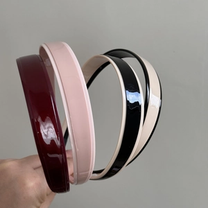 Set of four minimalist glossy headbands in burgundy, pink, black, and beige colors