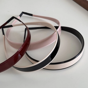 Set of four minimalist glossy headbands in burgundy pink and cream with black trim