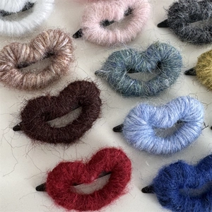 Detail view of heart-shaped plush hair clips with soft faux fur texture in various colors