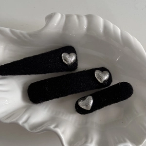 Set of 3 vintage black felt hair clips with textured silver heart accents on shell tray