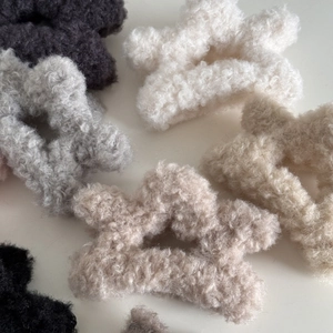 Star-shaped plush lamb wool hair claw clips in various neutral colors for women