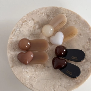 French style heart and bean hair clips in brown acetate colors on marble plate