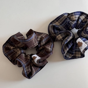 Plaid scrunchie set with cute bear patch, featuring earthy brown and navy blue patterns