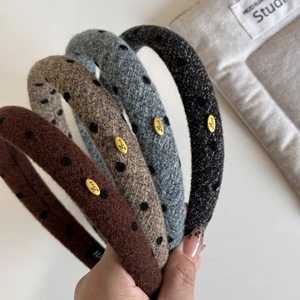 Polka dot sponge headbands in brown, grey, and black with oval gold Love buckles