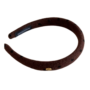 Brown plush headband with black polka dots and a gold metal oval plate for women