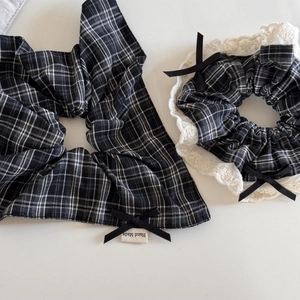 Plaid scrunchie set with black bow and lace trim detail on a minimalist white background