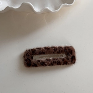 Close-up of a rectangular leopard print faux fur hair clip with soft plush texture