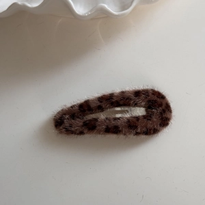 Macro shot of fluffy leopard print BB hair clip with soft plush texture for winter